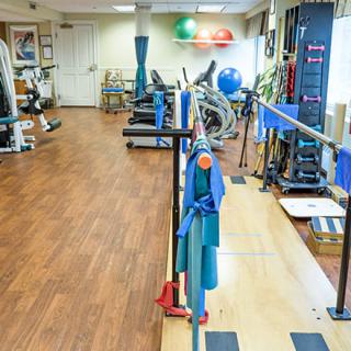 A well-equipped physical therapy and rehabilitation center with various exercise machines.