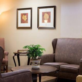 A cozy living room with comfortable seating and decorative elements.