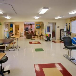 A physical therapy clinic featuring exercise equipment and treatment areas.