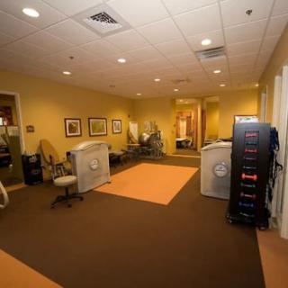 Spacious office interior with workstations and equipment.