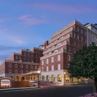 A brick hotel building with multiple stories, captured during the evening.