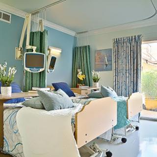 A well-lit and modern hospital patient room designed for comfort and care.