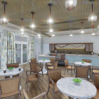 A cozy dining area with tables and chairs, featuring warm lighting and tasteful decor.