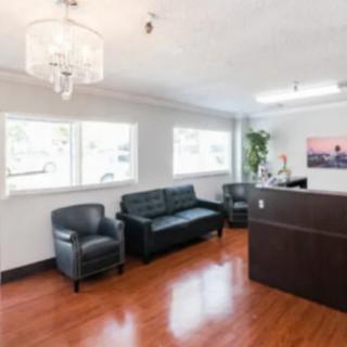 A modern office lobby with comfortable seating and a reception desk.