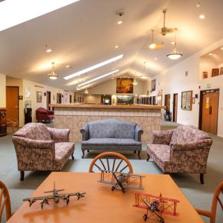A cozy lobby with comfortable seating and model airplanes on display.