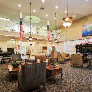 A spacious and elegantly decorated lobby area with comfortable seating and warm lighting.
