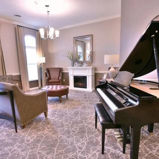 Elegant living room with a grand piano and cozy seating area.