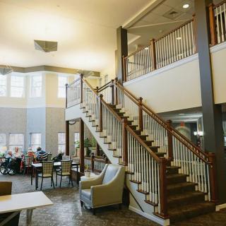 A modern lobby area featuring a prominent staircase and comfortable seating.