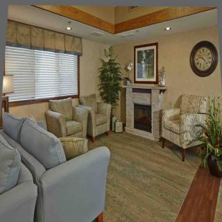 A cozy living room with comfortable seating and elegant decor.