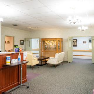 A welcoming waiting area in a medical facility, featuring comfortable seating and a reception desk.