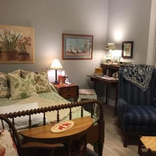 A cozy vintage bedroom with classic furniture and warm lighting.