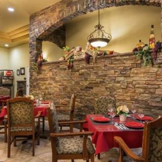 A cozy restaurant dining area with brick walls and elegant decor.