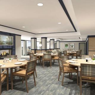 A modern restaurant dining area with neatly arranged tables and chairs.