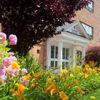 A vibrant garden with colorful flowers in front of a house entrance.