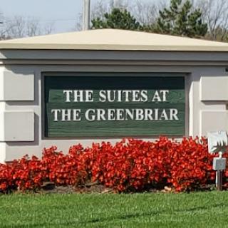Welcome to The Suites at The Greenbriar, surrounded by vibrant landscaping.