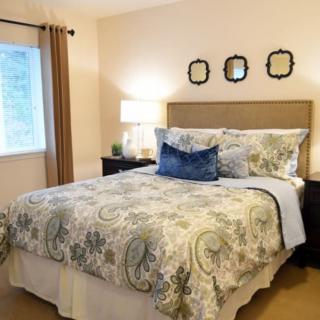 Cozy bedroom with elegant bedding and warm lighting.