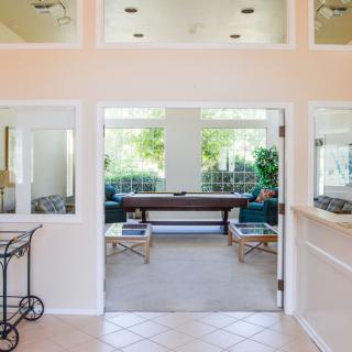 A bright and spacious interior living area with large windows and comfortable seating.