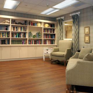A cozy reading room with armchairs and bookshelves.