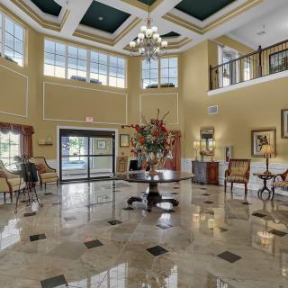 A luxurious and spacious hotel lobby with elegant decor and a marble floor.