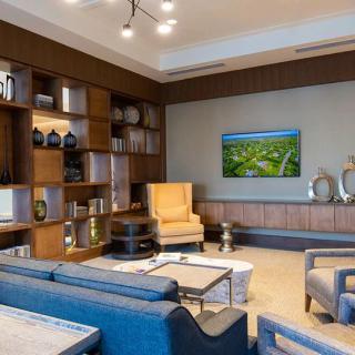 A modern living room with stylish furniture and decorative shelving.