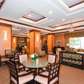 An elegant dining area featuring wooden furniture and modern ceiling lights.