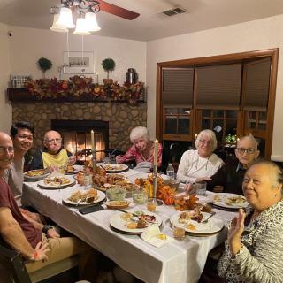 A family gathered around a table enjoying a holiday meal together.