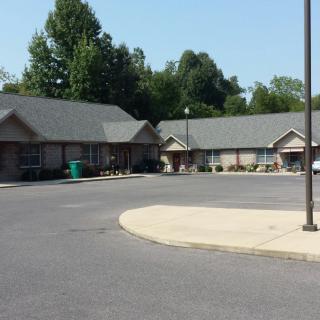 A view of a suburban residential area with several buildings and a parking lot.