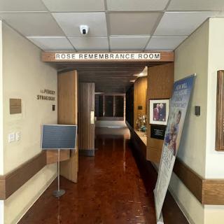 A view of a hospital hallway leading to different rooms.
