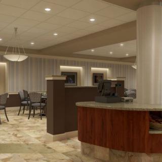 A modern lobby with a reception desk and seating area.