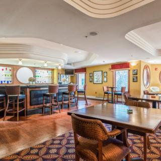 An elegant restaurant bar area with tables and comfortable seating.