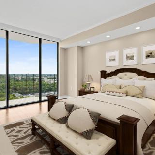 A beautifully designed modern bedroom with large windows offering a serene view.