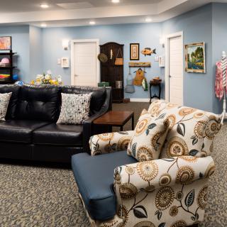 A cozy living room with comfortable seating and colorful decor.