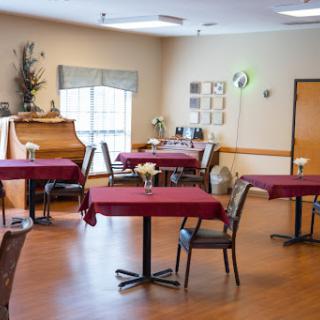 A cozy dining area with red tablecloths and a warm atmosphere.