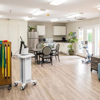 A therapy room equipped with exercise equipment and medical tools, designed for rehabilitation purposes.