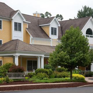A suburban house with well-maintained landscaping and a covered porch.