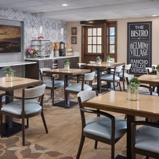 A modern bistro dining area with neatly arranged tables and chairs.
