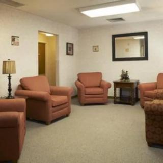 A cozy waiting room with comfortable seating and soft lighting.