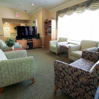 A cozy living room with comfortable seating and a large television.