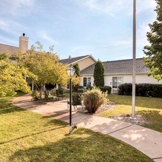 A quaint house with a well-maintained garden and pathway.