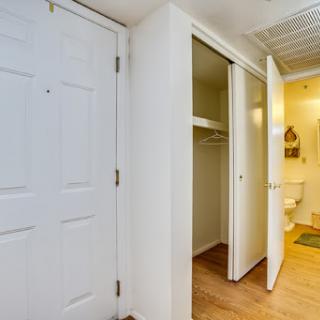 A spacious entryway featuring white doors and a closet.
