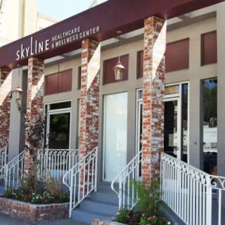 A view of a commercial business entrance with a brick facade and awning.