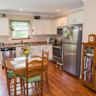 A cozy kitchen with a dining table and stainless steel appliances.