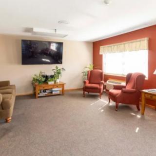 A cozy living room with comfortable seating and a large television.
