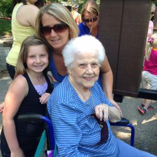A family photo with three generations enjoying time outdoors.