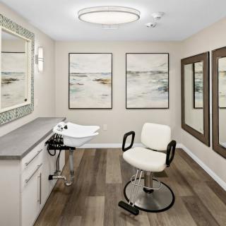 A modern hair salon interior with a barber chair, sink, and elegant wall art.