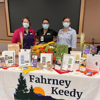 Staff members showcasing resources at the Fahrney Keedy event.
