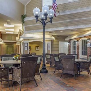 A cozy indoor seating area with tables, chairs, and a decorative lamp post.