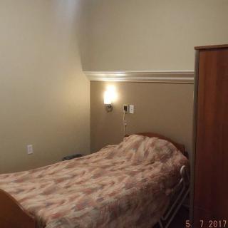 A room with a hospital bed and simple decor.