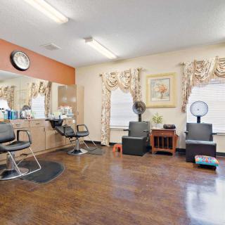 A well-arranged hair salon with chairs, mirrors, and salon equipment.