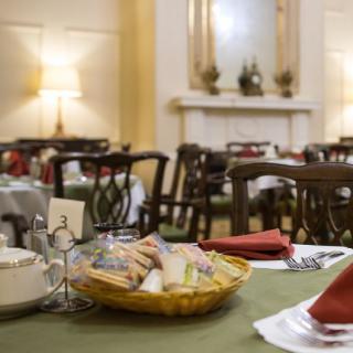 A cozy dining room with elegantly set tables, ready for guests.